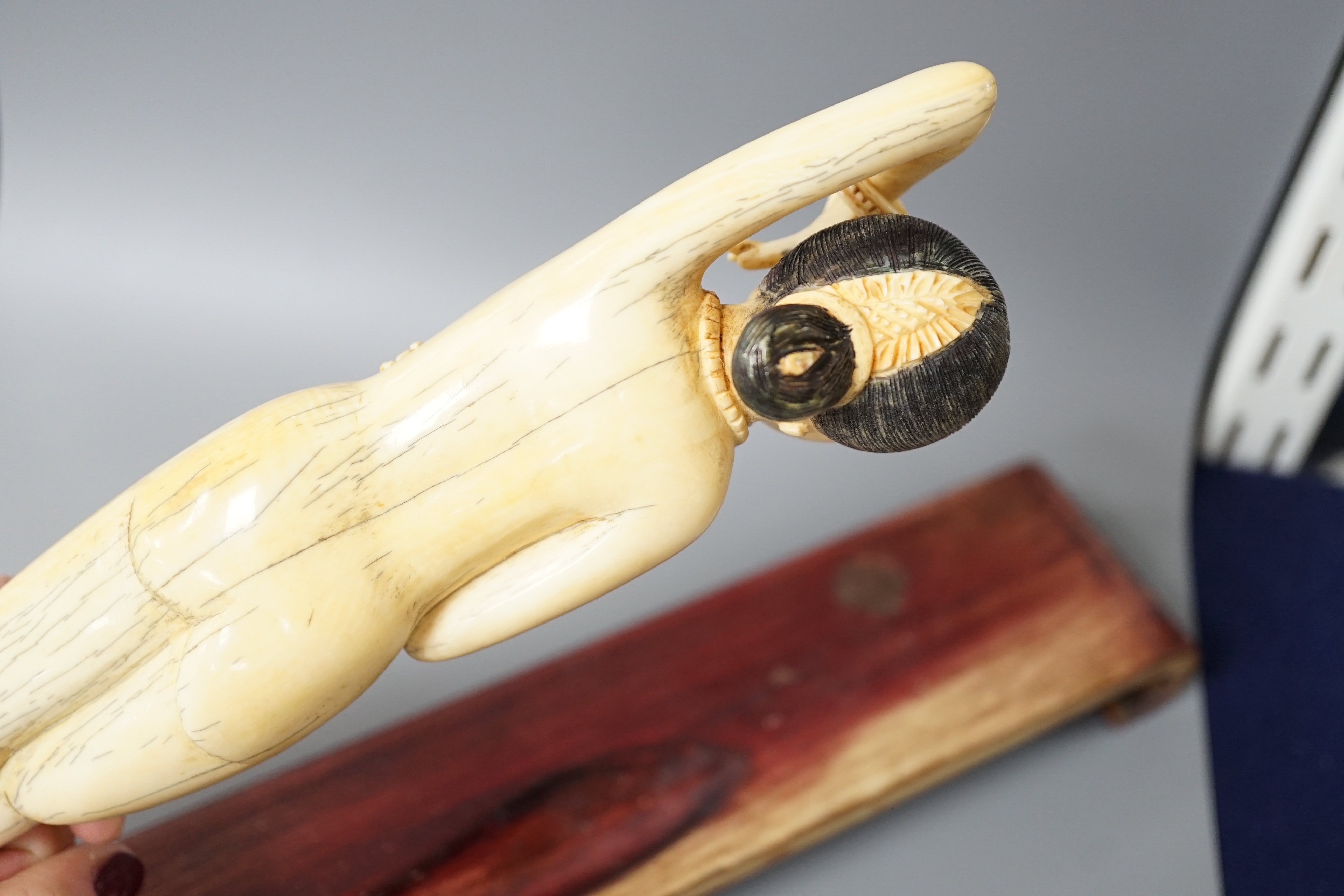 A Chinese carved ivory medicine figure, late 19th/early 20th century, wood stand. 25cm excl stand